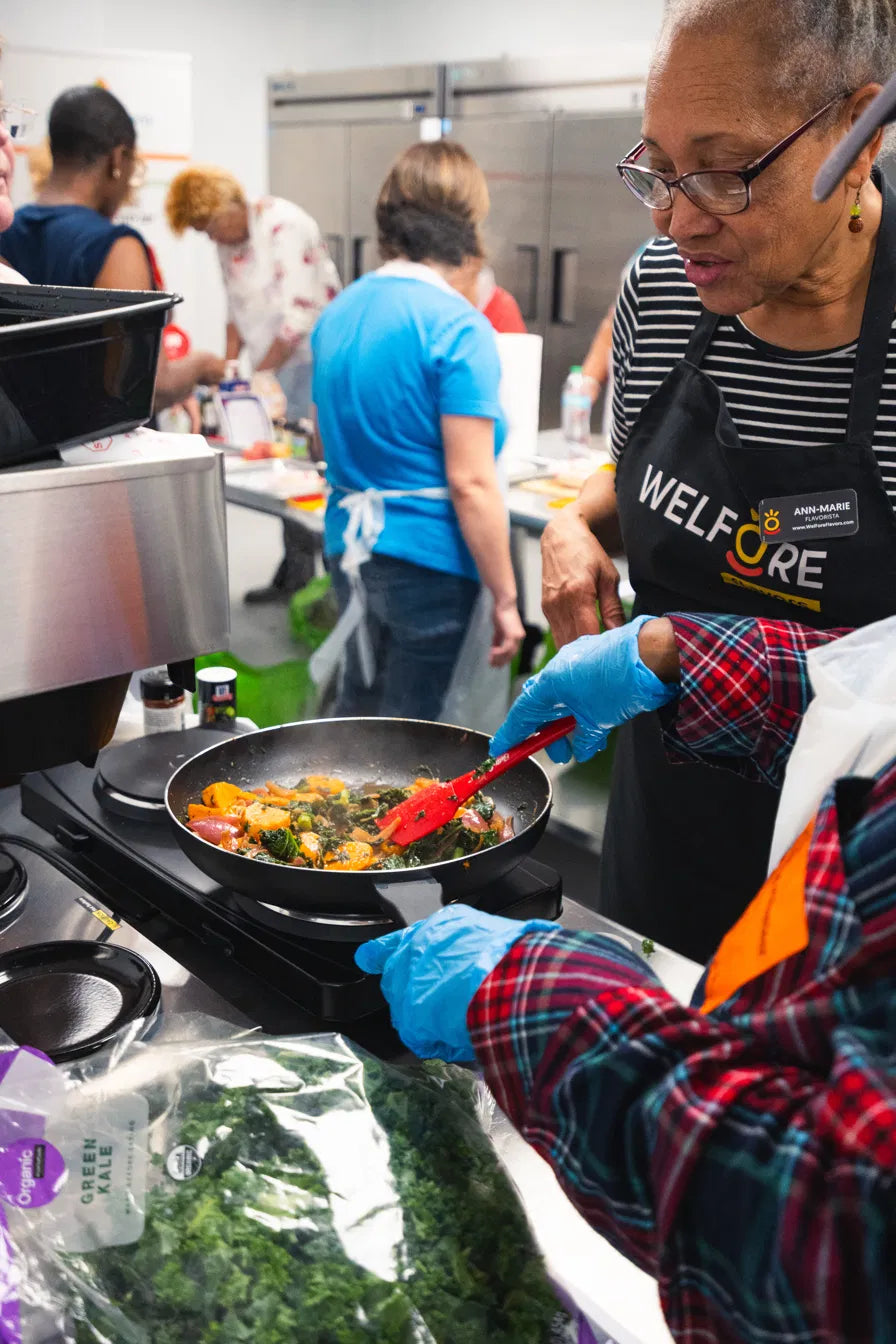 WelFore team members and participants preparing food during a community cooking class.